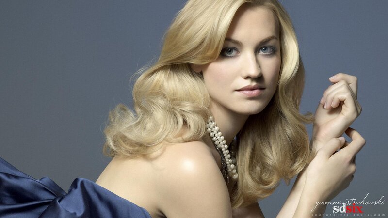 woman with blonde hair and pearls