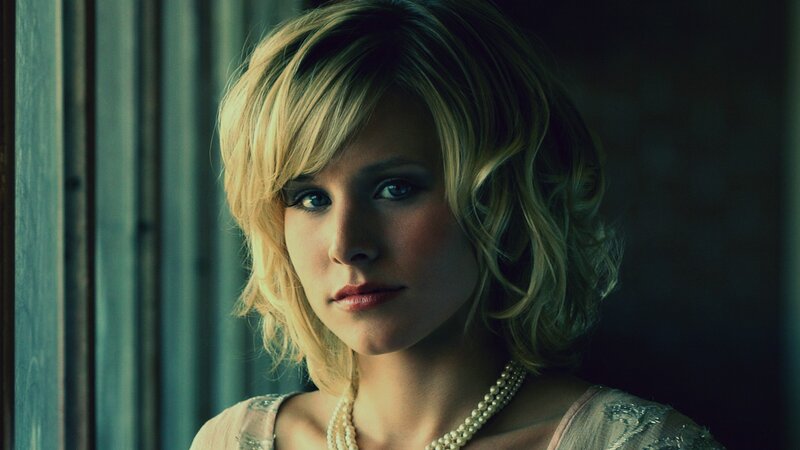 woman with blonde hair and pearls