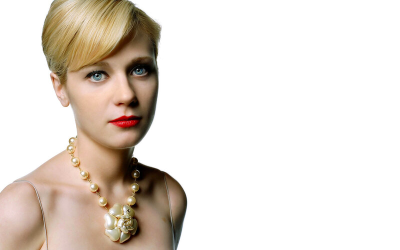 woman with blonde hair and pearls