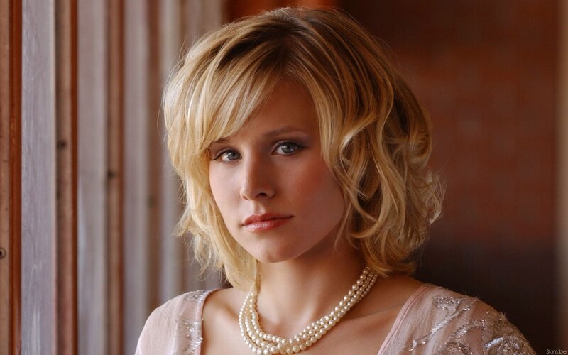 woman with blonde hair and pearls