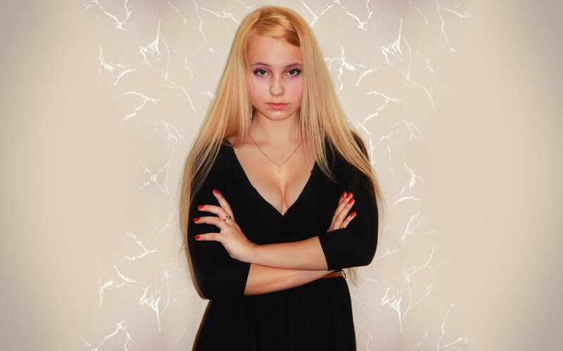 woman with blonde hair and purple makeup