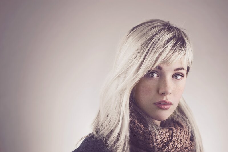 woman with blonde hair and scarf
