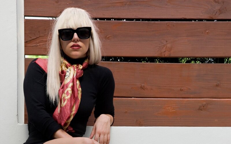woman with blonde hair and sunglasses