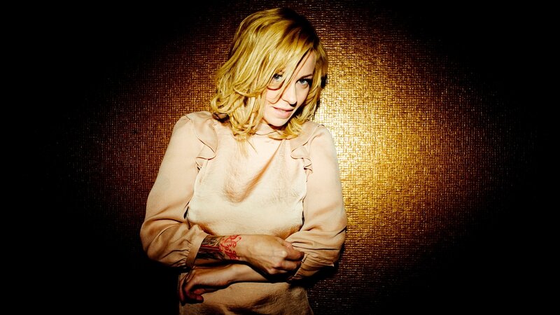 woman with blonde hair and tattoo