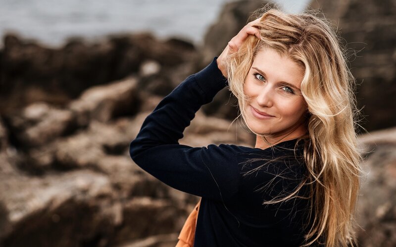 woman with blonde hair at the coast