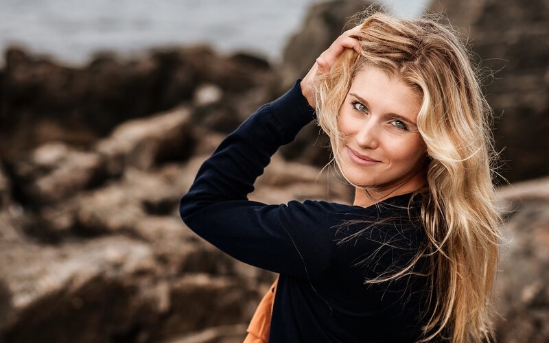 Woman with blonde hair at the coast