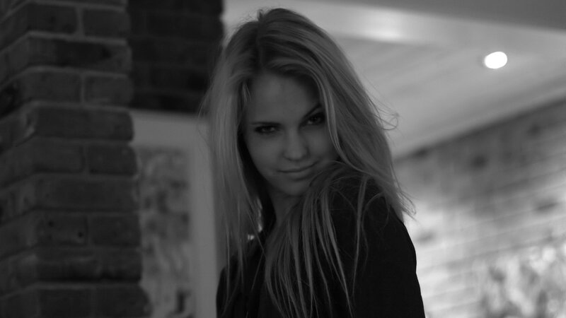 Woman with Blonde Hair — Black, Dramatic, Photograph, Brick Wall, Ceiling Light