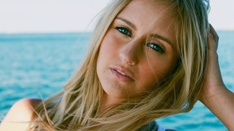 woman with blonde hair by the sea