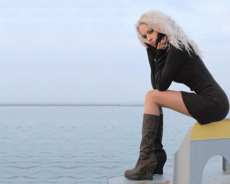 Woman with blonde hair by the water
