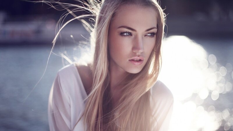woman with blonde hair by water