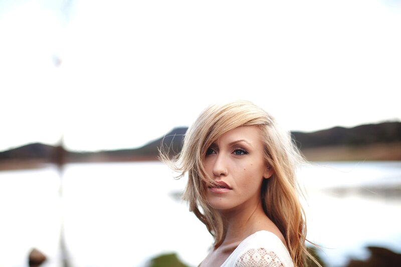 woman with blonde hair by water