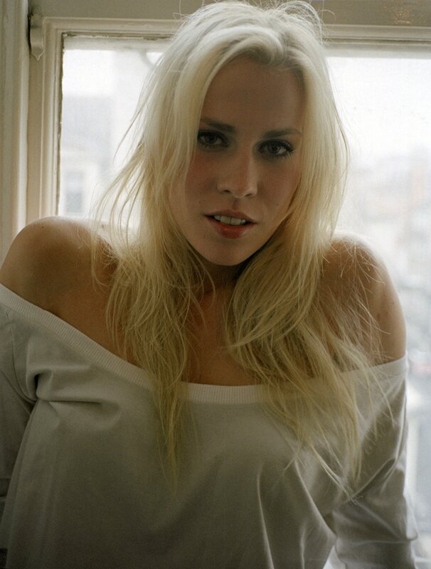 woman with blonde hair by window