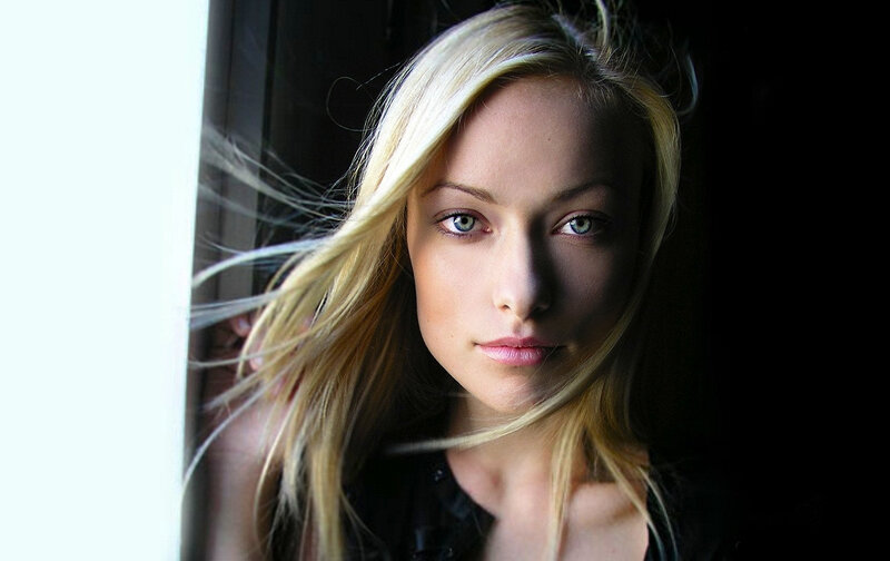 woman with blonde hair by window