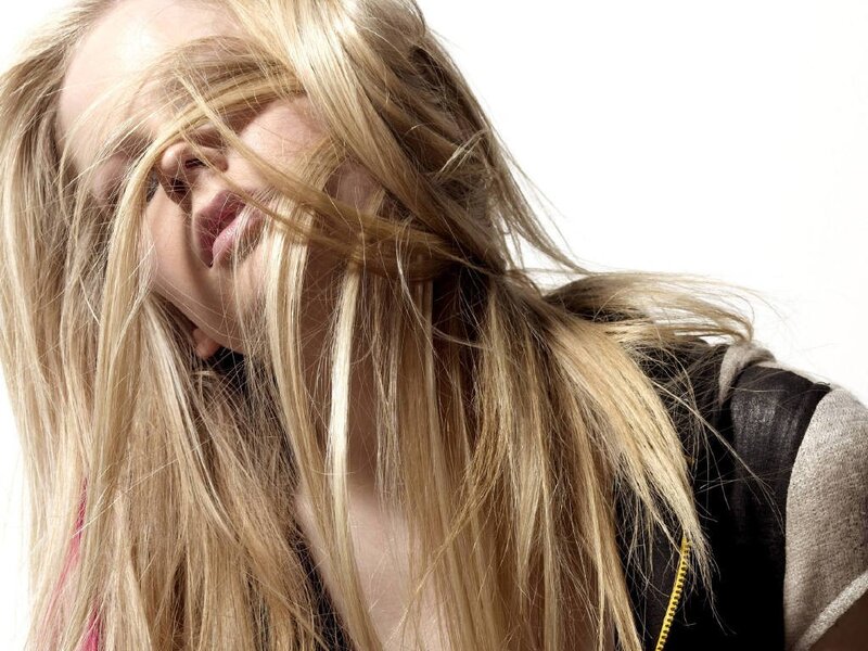 woman with blonde hair covering face