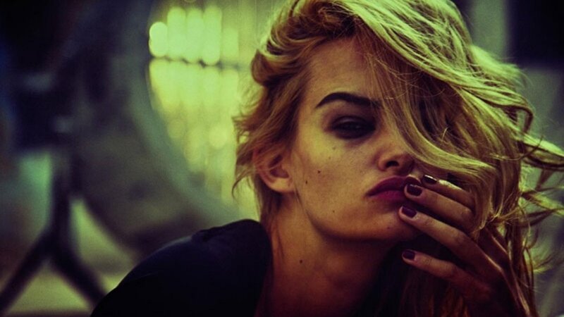 woman with blonde hair covering face