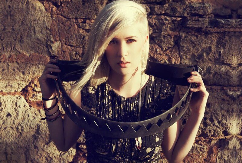 woman with blonde hair holding metal object