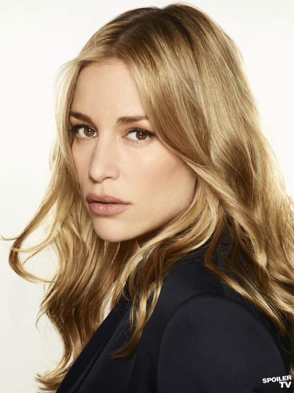 woman with blonde hair in a dark blazer