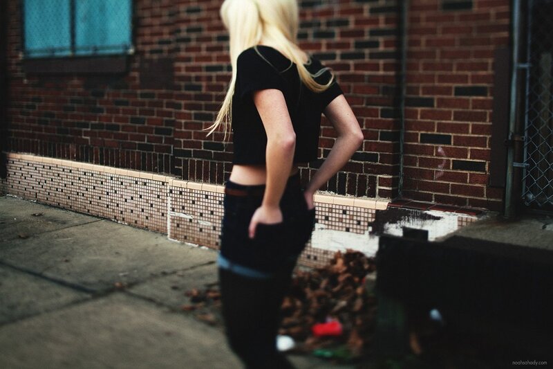 woman with blonde hair in alley