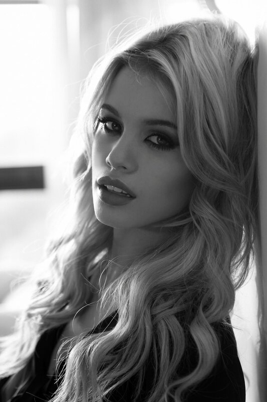 woman with blonde hair in black and white