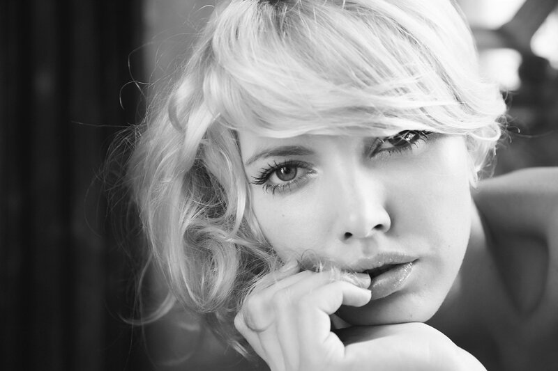 woman with blonde hair in black and white