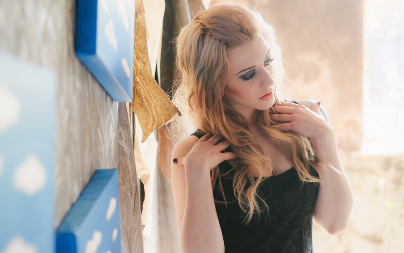 woman with blonde hair in black dress