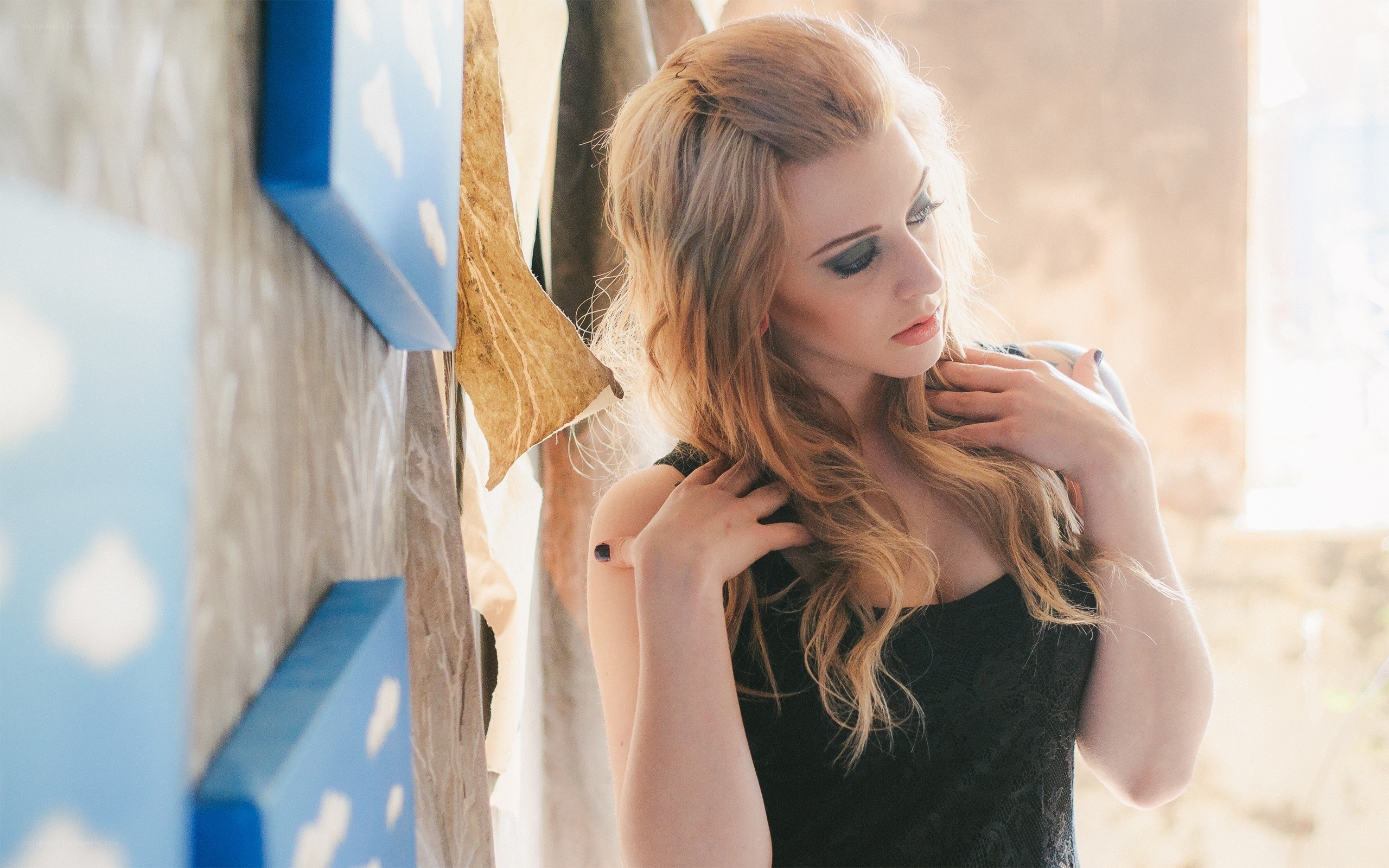 woman with blonde hair in black dress