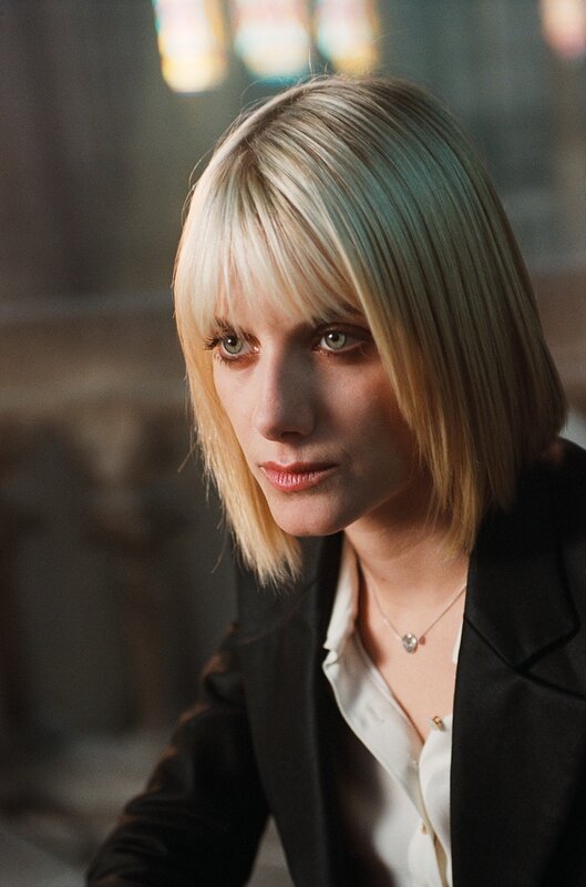 woman with blonde hair in black jacket