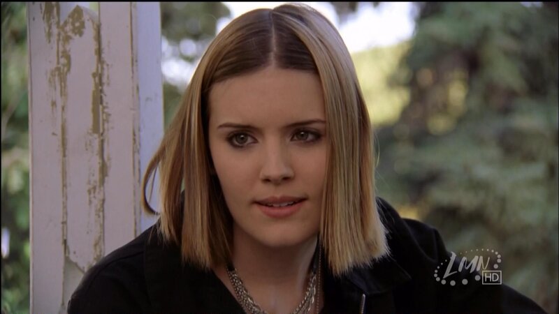 woman with blonde hair in black jacket