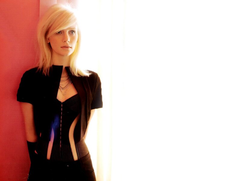 woman with blonde hair in black outfit