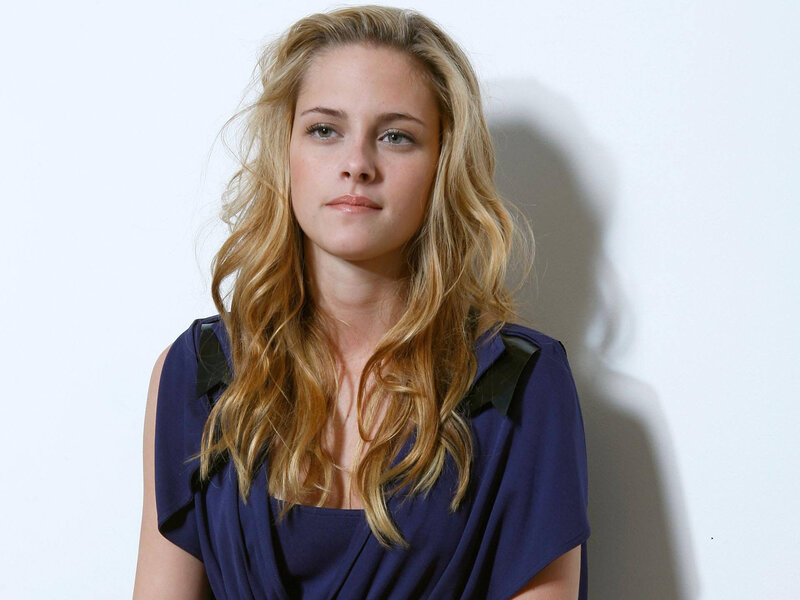 woman with blonde hair in blue top