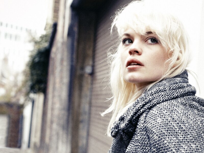 woman with blonde hair in coat