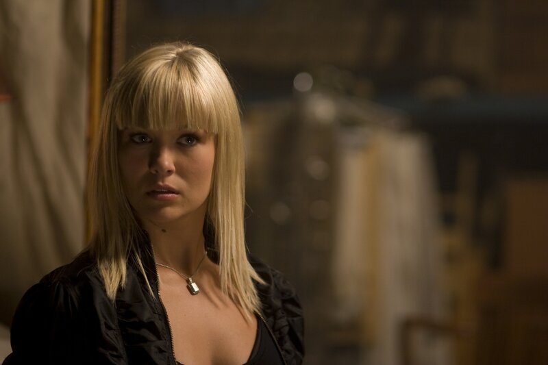 woman with blonde hair in dark room