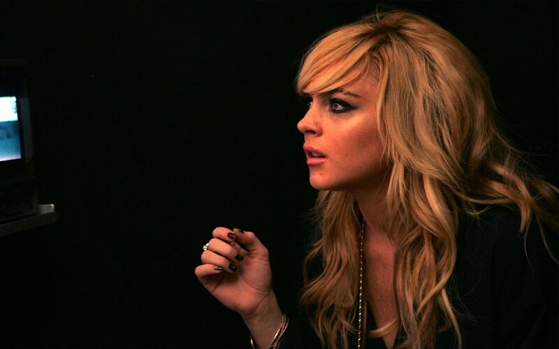 woman with blonde hair in dark room