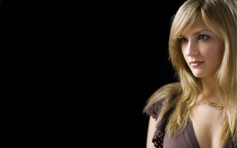 woman with blonde hair in dark setting