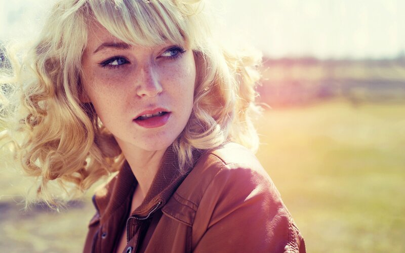 woman with blonde hair in field