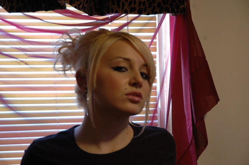 woman with blonde hair in front of window