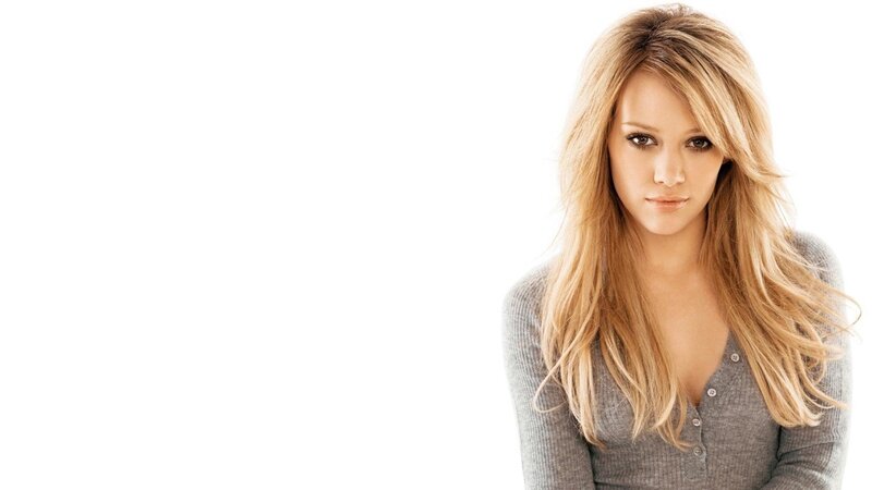 woman with blonde hair in gray sweater