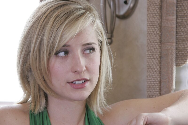 woman with blonde hair in green top