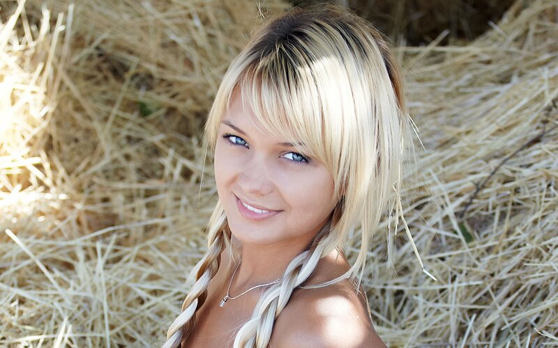 woman with blonde hair in hay