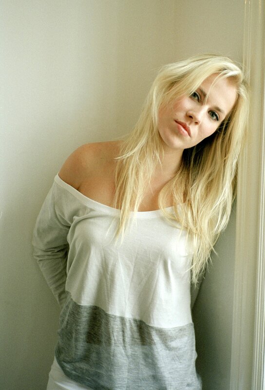 woman with blonde hair in off-shoulder top