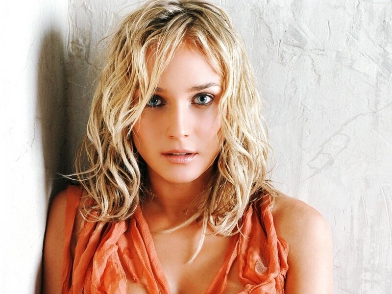 woman with blonde hair in orange top