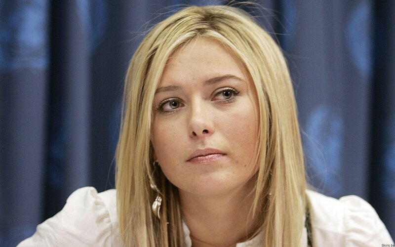 woman with blonde hair in white shirt