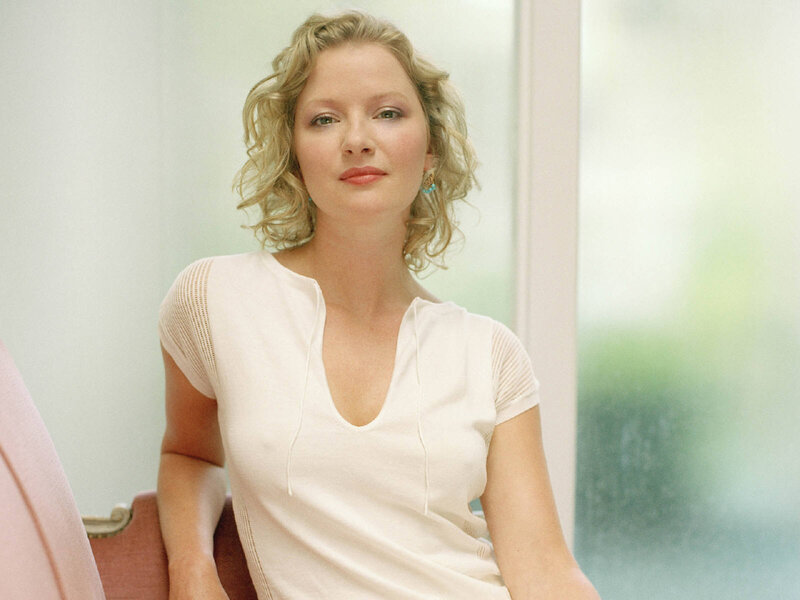 woman with blonde hair in white top