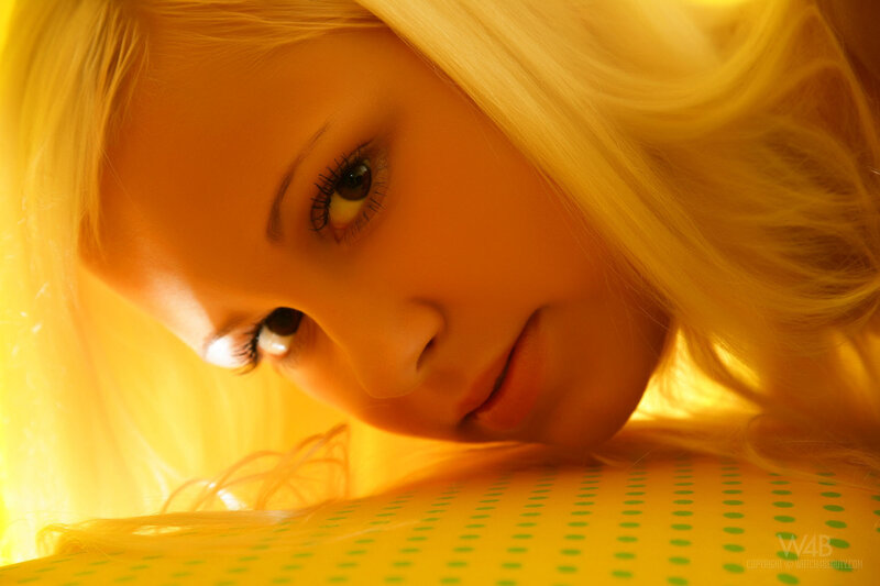 woman with blonde hair in yellow light
