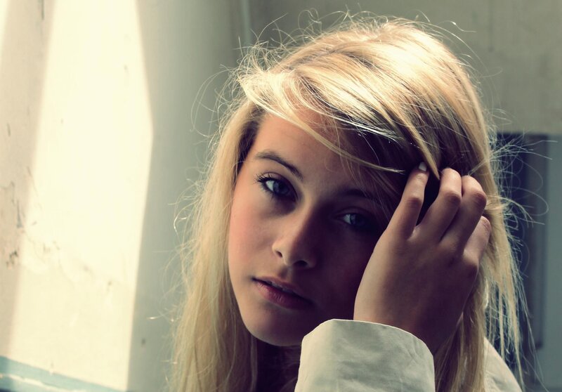 woman with blonde hair looking at camera