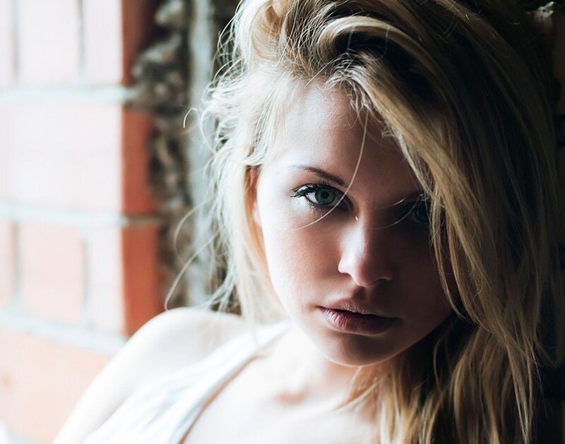 woman with blonde hair looking at camera