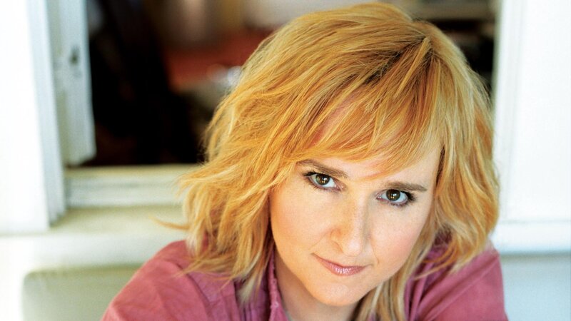 woman with blonde hair looking at camera