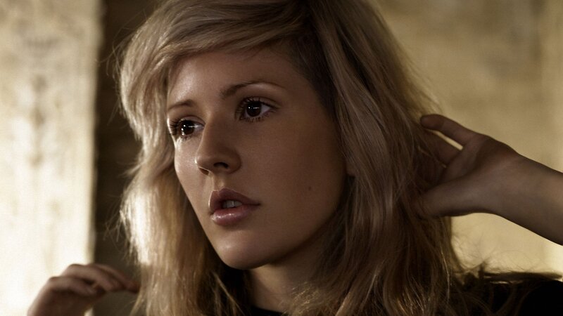 woman with blonde hair looking away