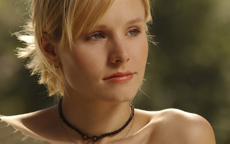 woman with blonde hair looking away