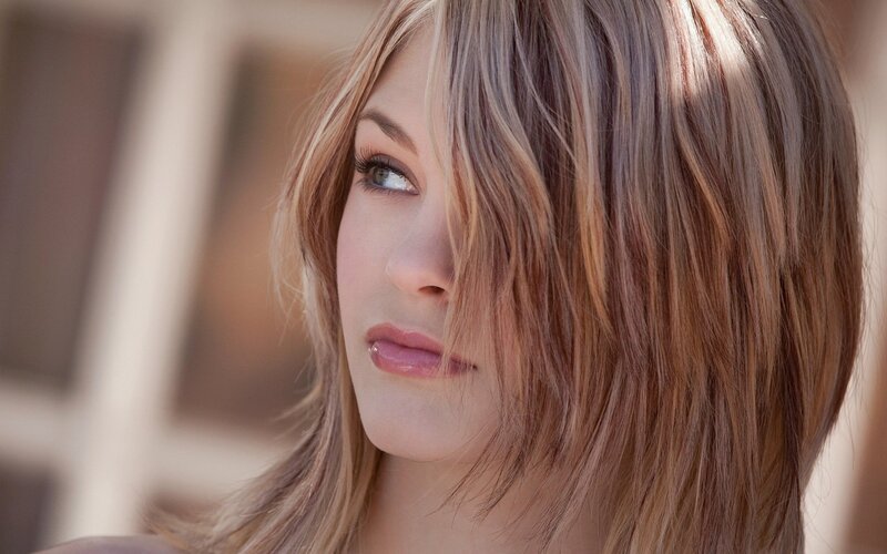 woman with blonde hair looking away